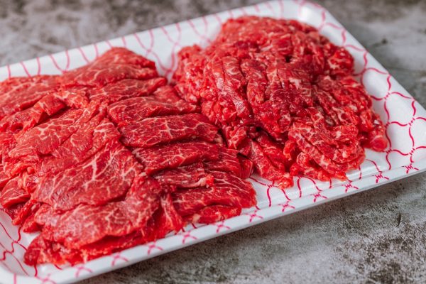 fresh raw beef meat on black table